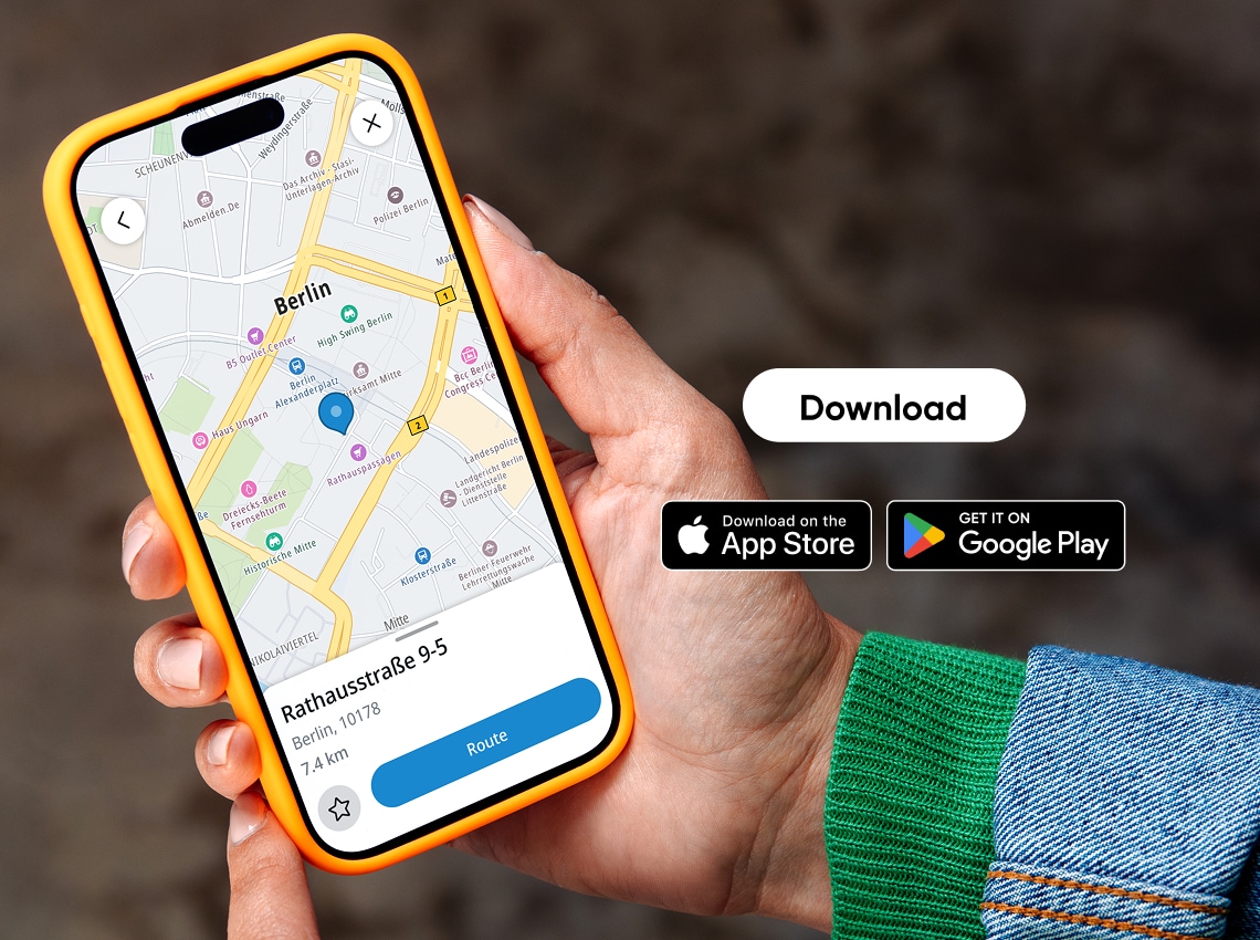 Hand holding a smartphone with a map of Berlin on screen; app download buttons for App Store and Google Play are visible.