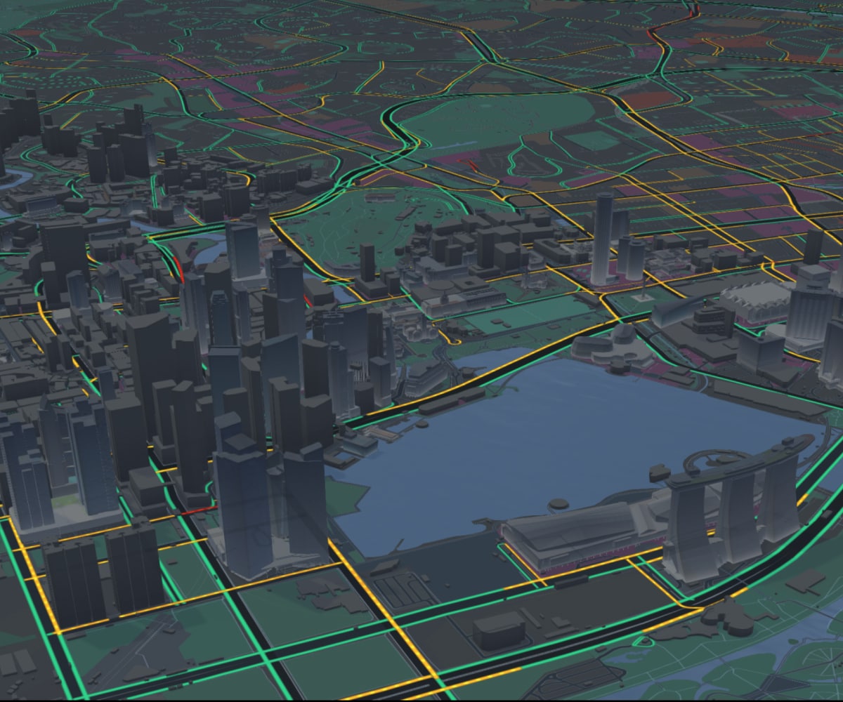 Futuristic cityscape with illuminated roads, dense skyscrapers, and a waterfront area, viewed from an elevated angle at night.