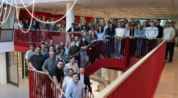 Large group of employees standing on the staircase posing for a photo