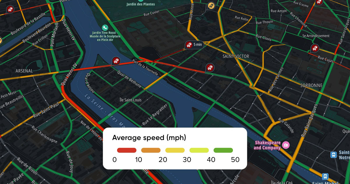 A city map showing traffic conditions with color-coded routes indicating average speeds in mph and transport icons for buses.