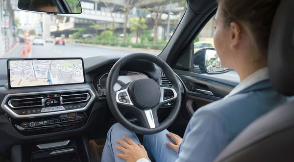 a hands-free driver in an automated vehicle with a screen clearing showing the road ahead