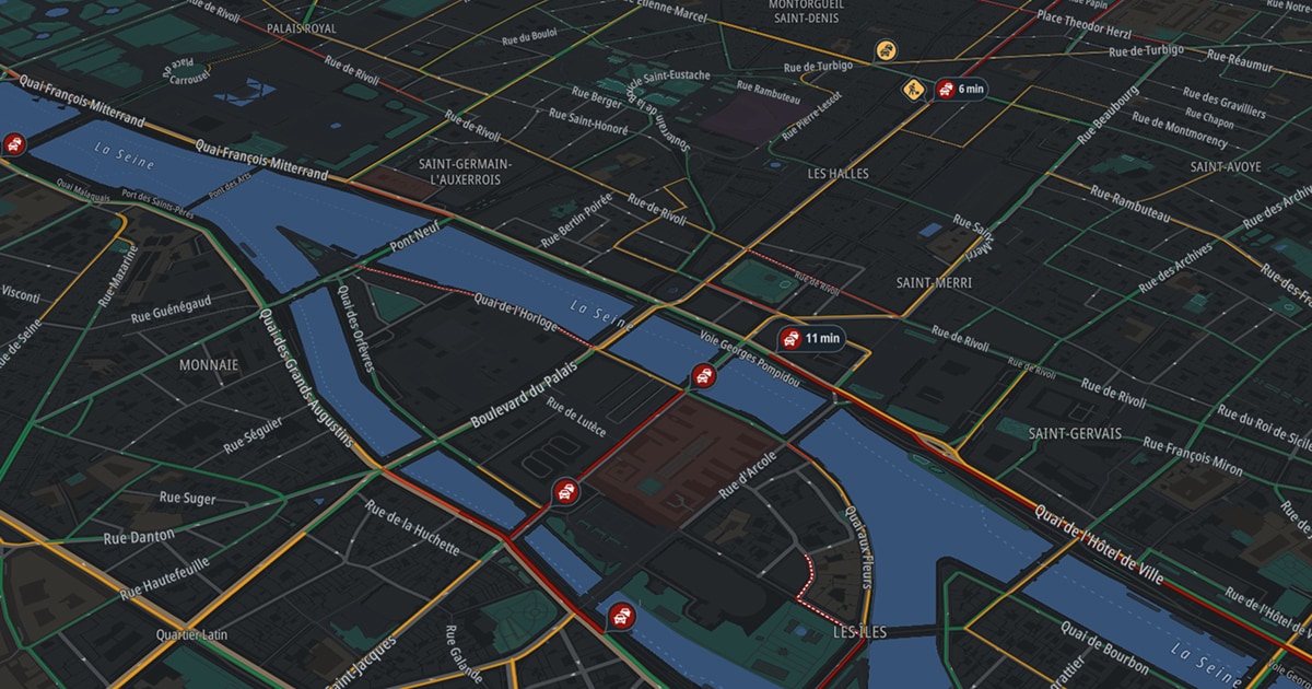A map showing traffic conditions in Paris, highlighting roads near the Seine River with estimated travel times and traffic icons.