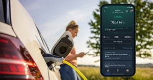 Vehicle plugged in to EV charger as its driver uses an app to control EV charging