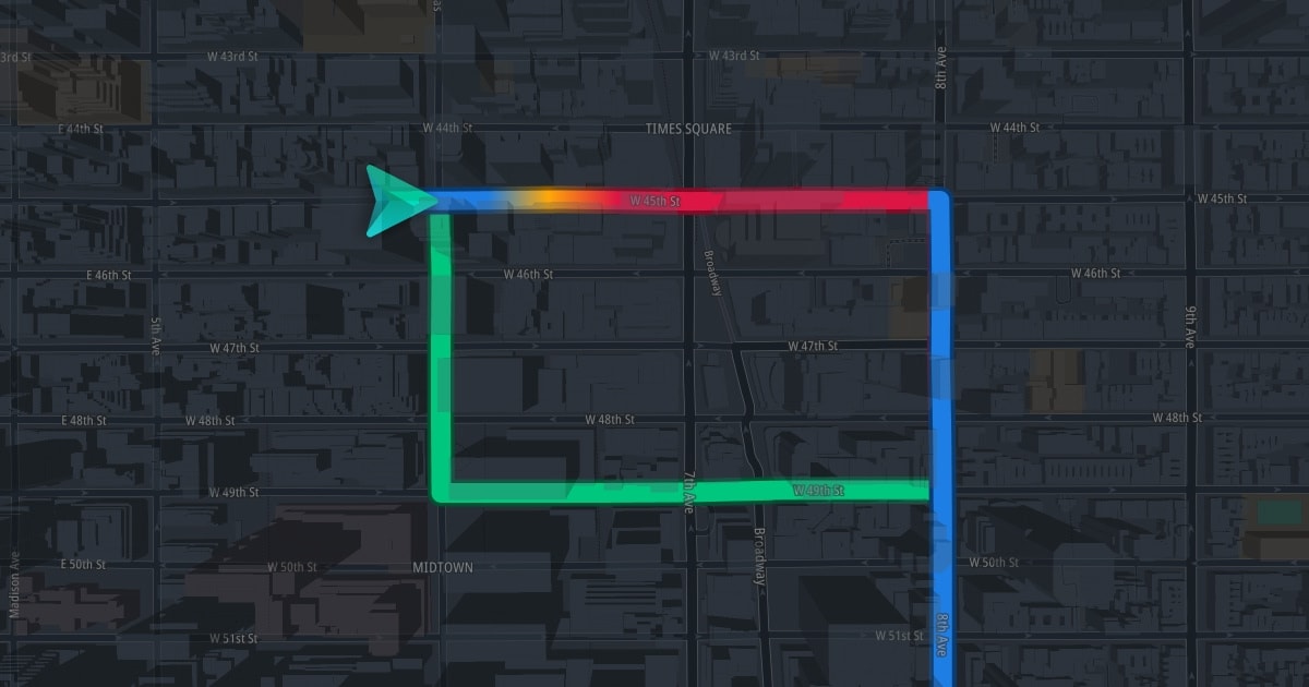 Digital map showing a highlighted route in New York City. The path is marked in colors and leads to Times Square, featuring an arrow indicating direction.
