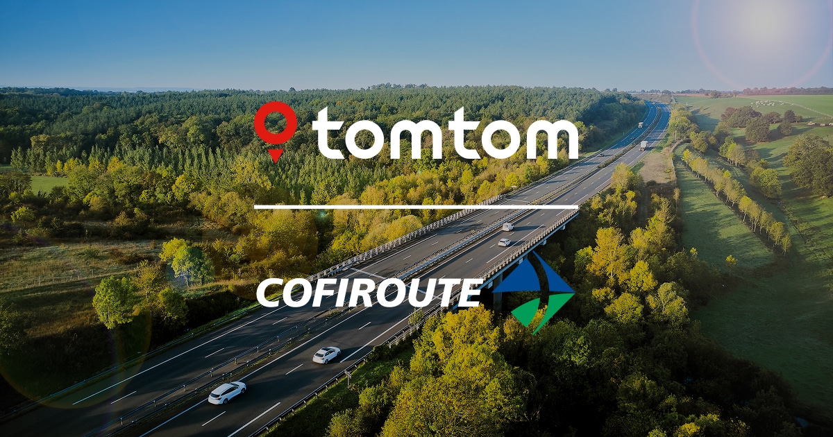 Aerial view of a highway surrounded by lush green forest with logos of TomTom and Cofiroute overlaying the image.