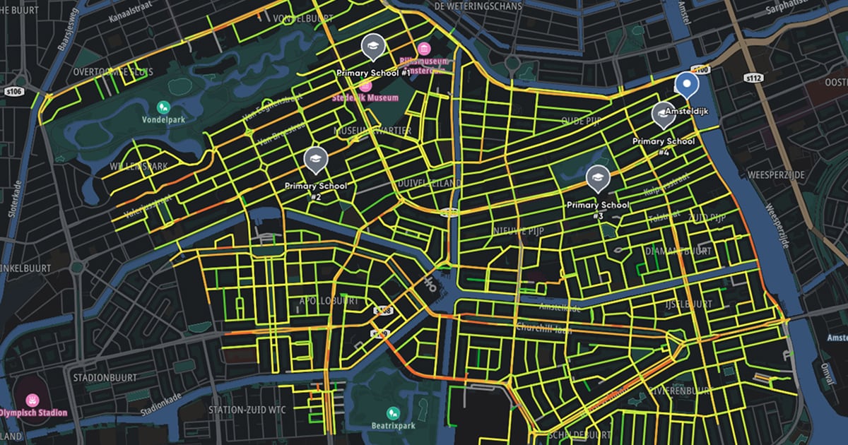 Map highlighting bicycle lanes and primary schools in Amsterdam, with streets marked in bright colors over a dark background.