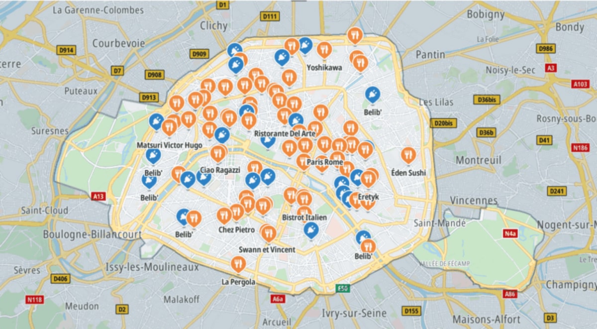 Map of Paris highlighting restaurants with orange icons and electric charging stations with blue icons distributed across the city.