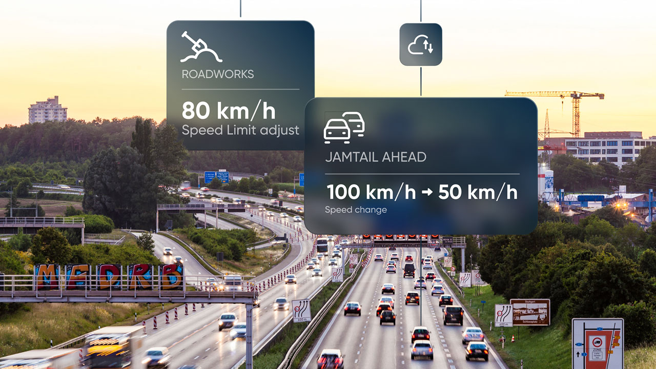 Highway traffic with digital signs indicating roadworks and speed changes from 100 km/h to 50 km/h at sunset.
