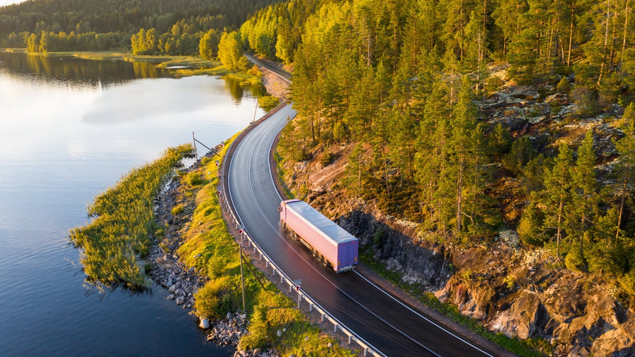 Truck driving on a highway through nature