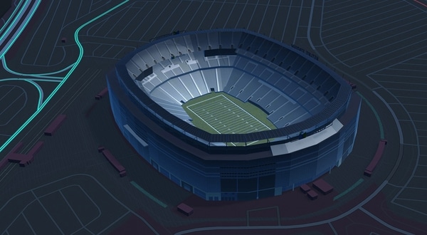 Aerial view of  MetLife Stadium at night, with surrounding roads and parking areas visible.