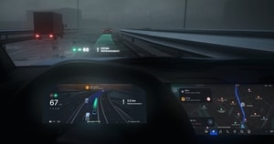 Car dashboard view showing a digital speedometer, GPS, and route navigation on a rainy highway with a truck ahead.