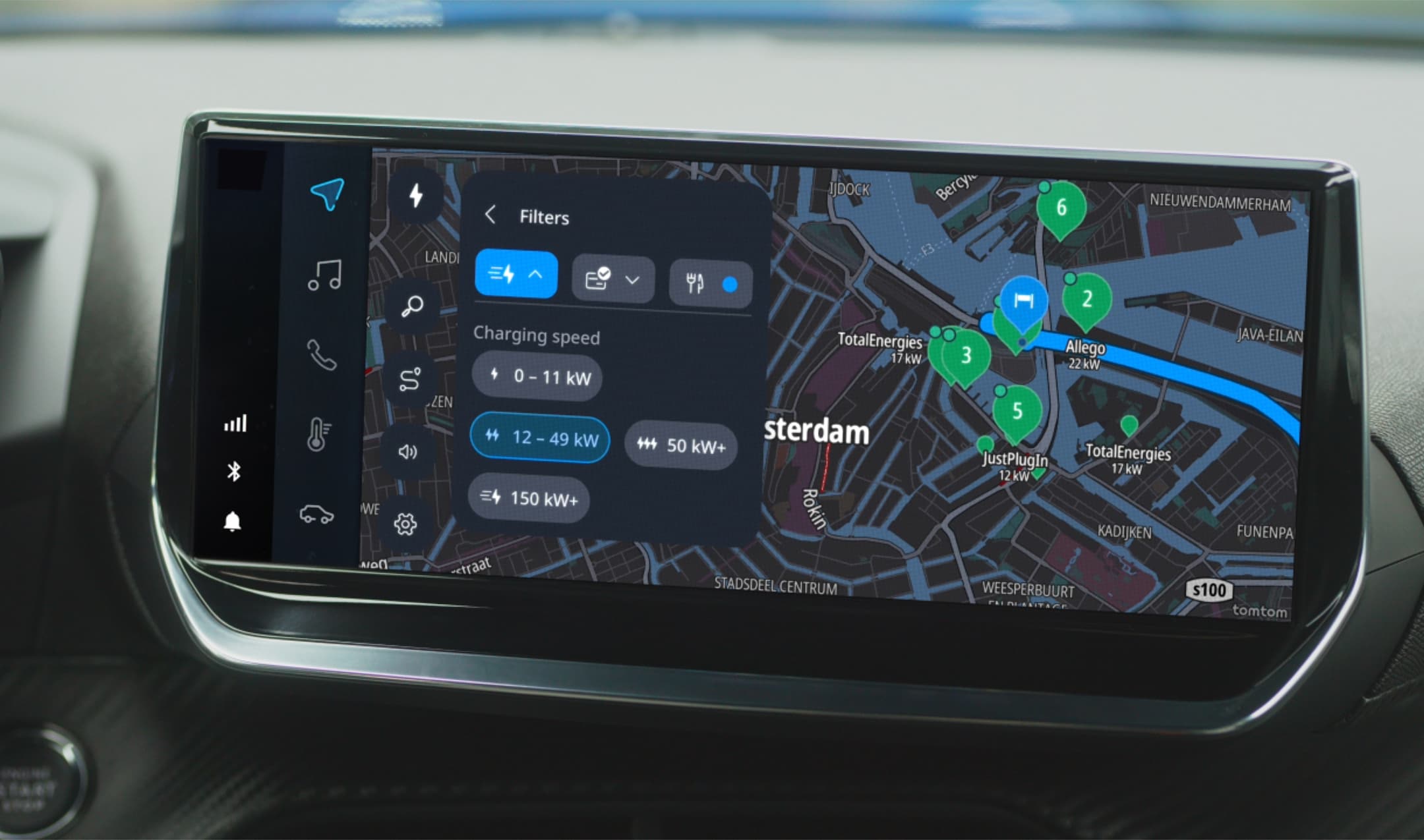 Car dashboard screen displaying a map of Amsterdam with electric vehicle charging stations marked and charging speed filter options visible.