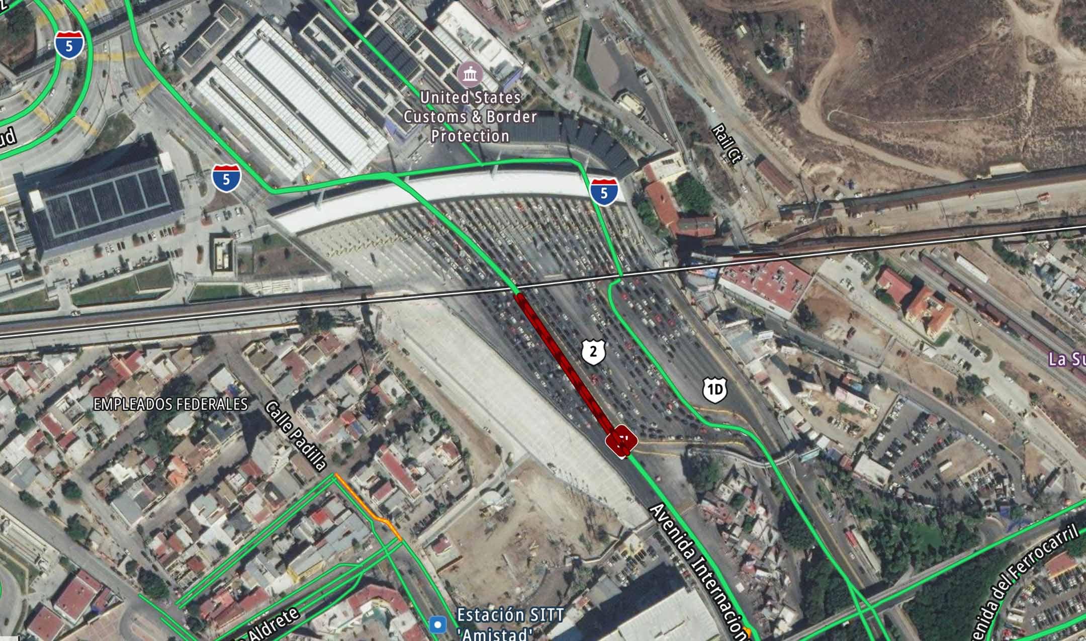 Aerial view of the United States Customs & Border Protection facility with surrounding roads in a busy urban area, indicating dense traffic.