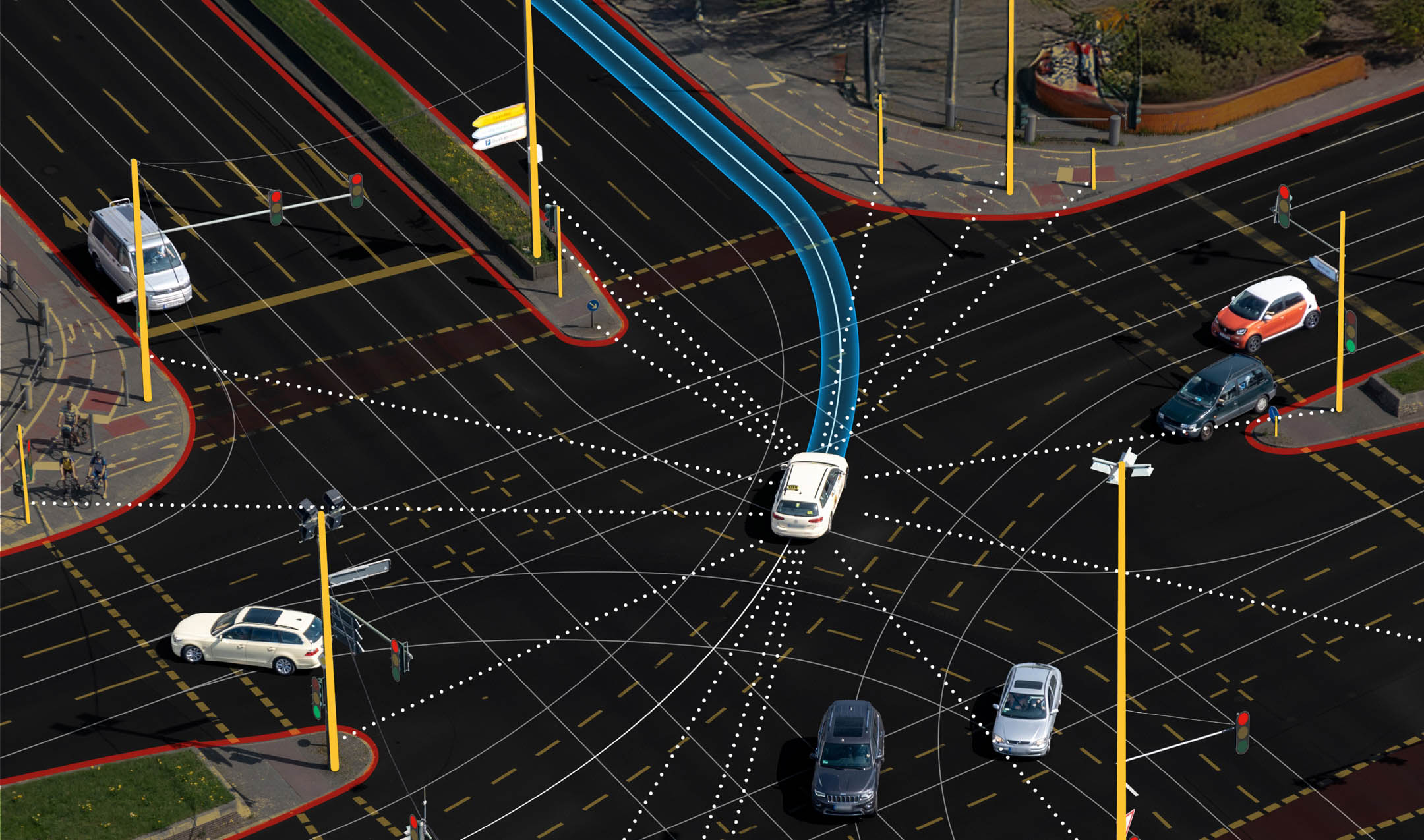 Aerial view of a busy intersection with cars and marked lanes, featuring blue directional arrows and dotted lines against the dark road.