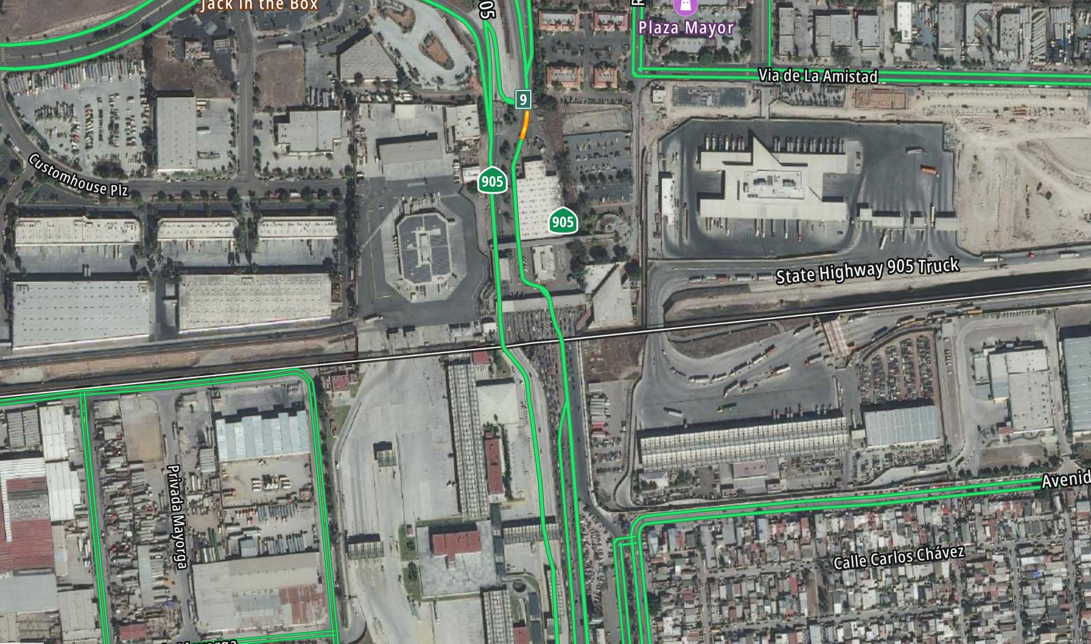 Aerial view of an urban area featuring roads labeled State Highway 905 Truck and Avenida Internacional, with nearby buildings and a parking lot.