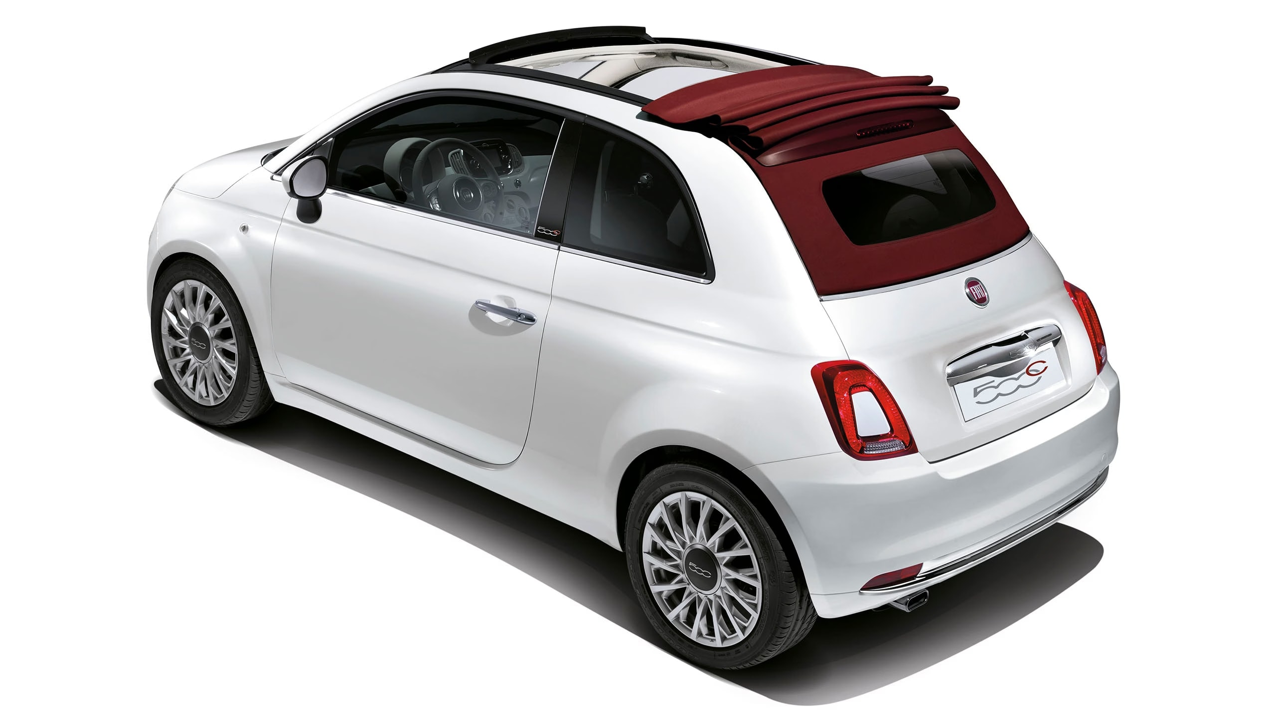 A white Fiat 500 with a red convertible roof.