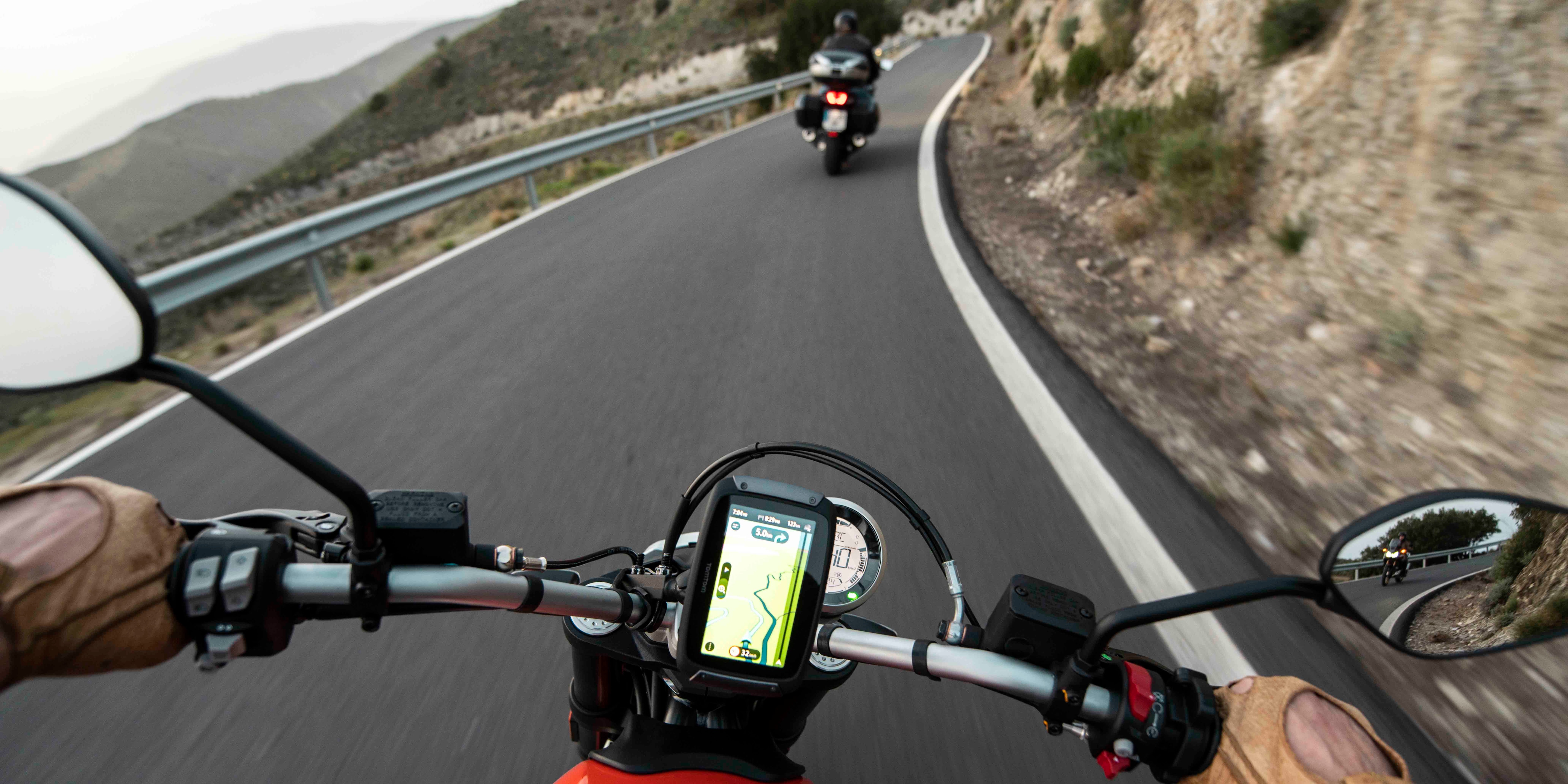 TomTom motorcycle sat nav device being used to guide driver